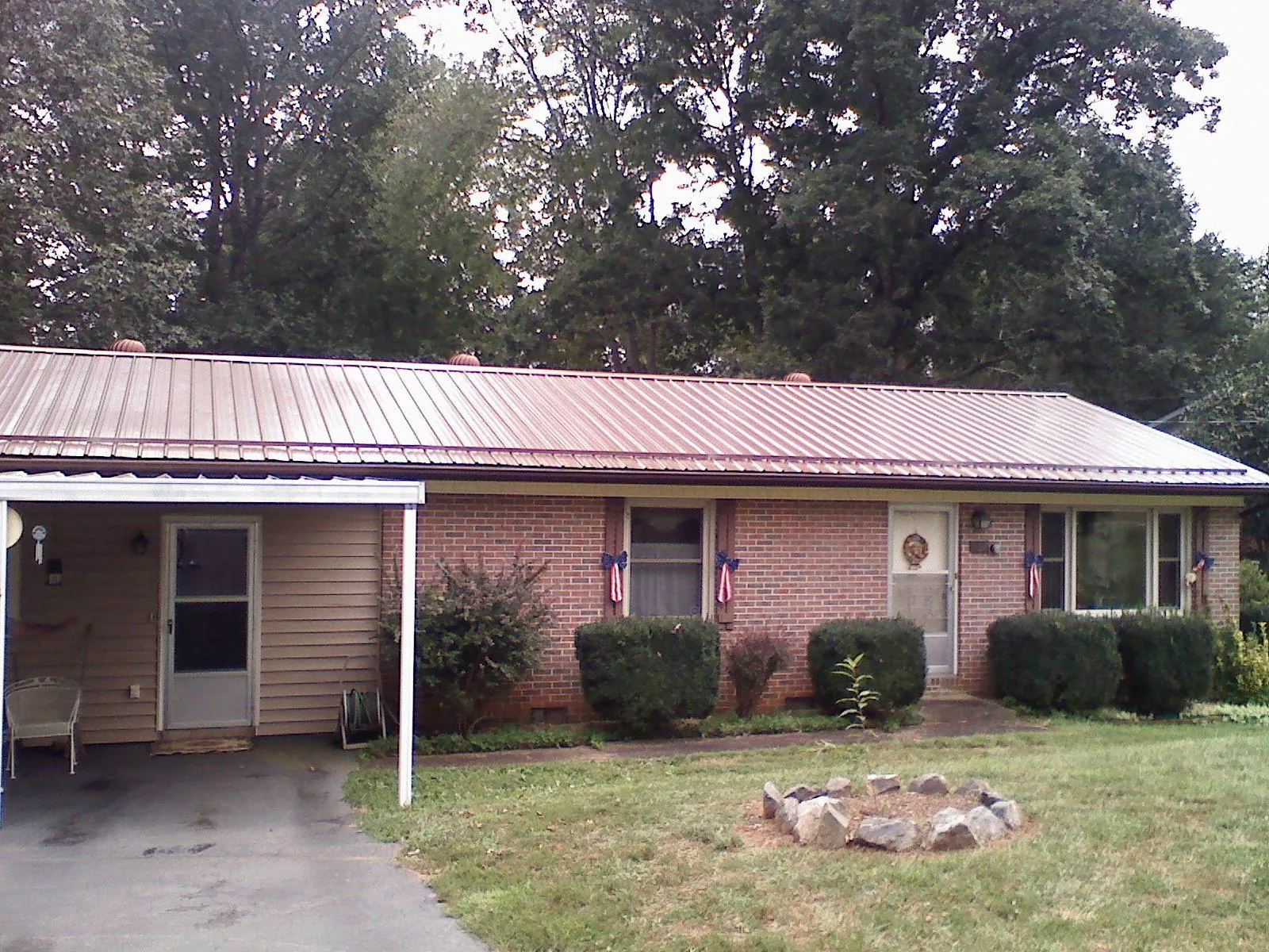 Bronze metal roof and carport on a brick ranch home — Roof Repair work by our crew in Evergreen Park
