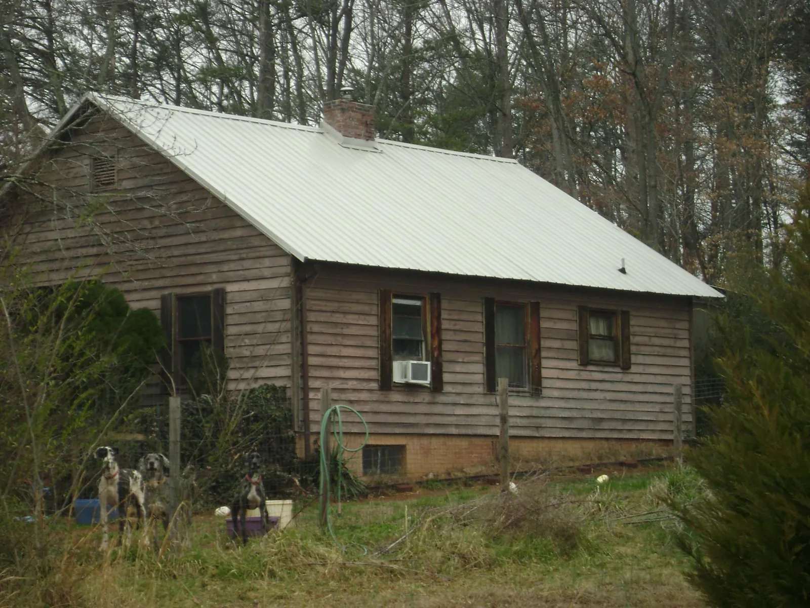 White metal roof on an old wood sided farmhouse, from a Metal Roof Installation job in Evergreen Park